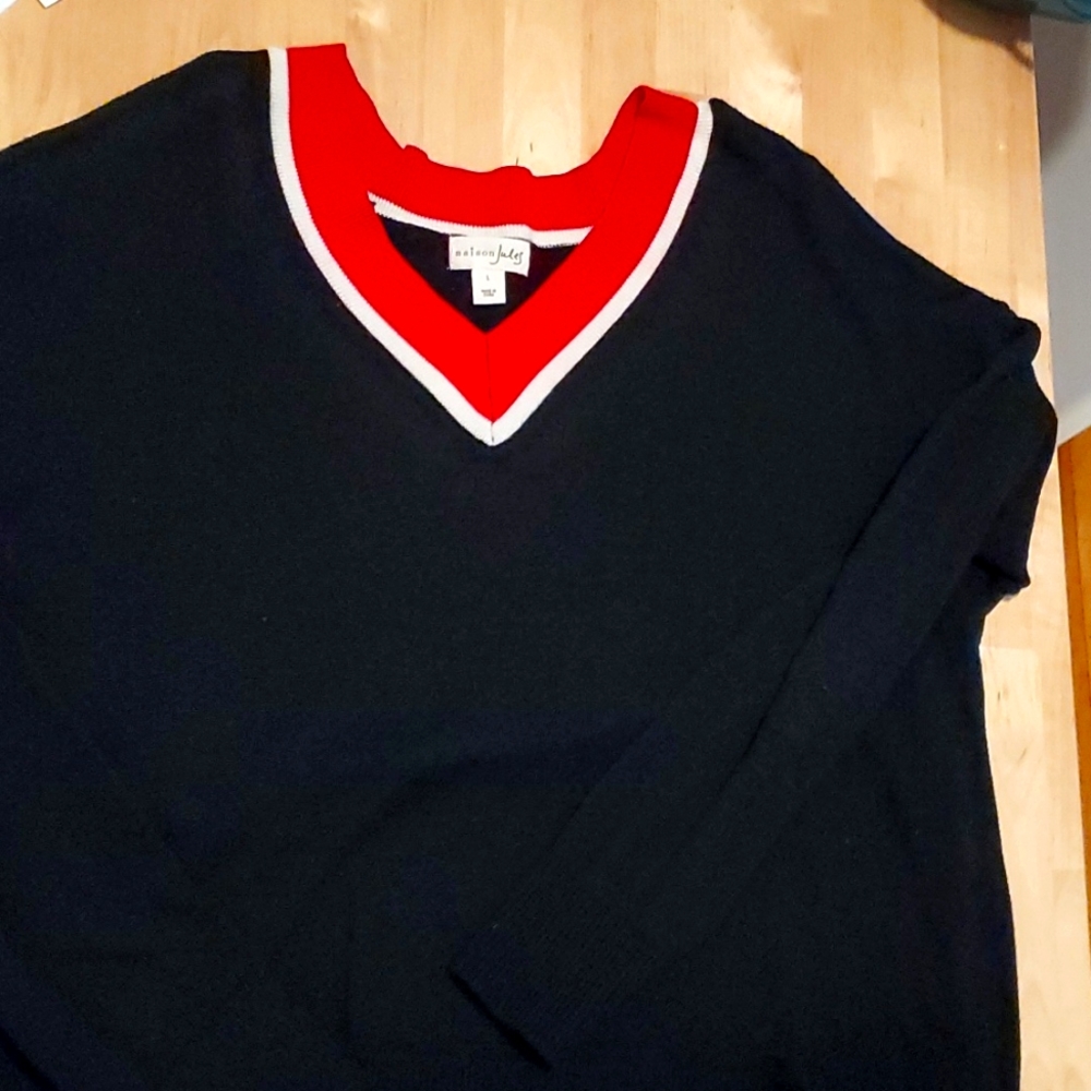 Solid Black Sweater with red around v-neck.
